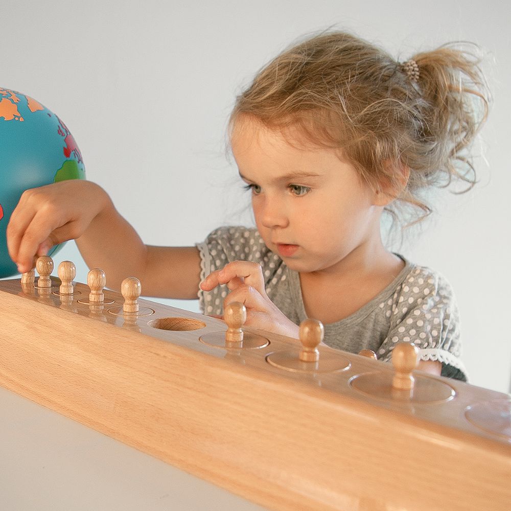 Child playing with a toy that helps her fine motor skills